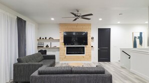 Smart TV, fireplace, books, computer monitors