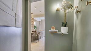 A modern bathroom with a minimalist design, featuring a white sink, a mirror, and a potted orchid. - Superb duplex in the center of Paris (Paris)