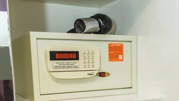 A white shelf with a white electronic device displaying '8888.8.8.8' and a warning label.