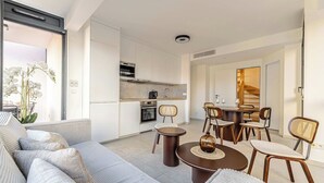 A modern apartment with a living area, dining space, and kitchenette. - Superb terrace apartment in Monaco-Beausoleil (Beausoleil)