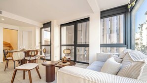 A modern living room with a sofa, chairs, a coffee table, and large windows. - Superb terrace apartment in Monaco-Beausoleil (Beausoleil)