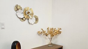 A modern room with a wooden console table, white drawers, and decorative wall art. - Malta View Prestige (Poznań)