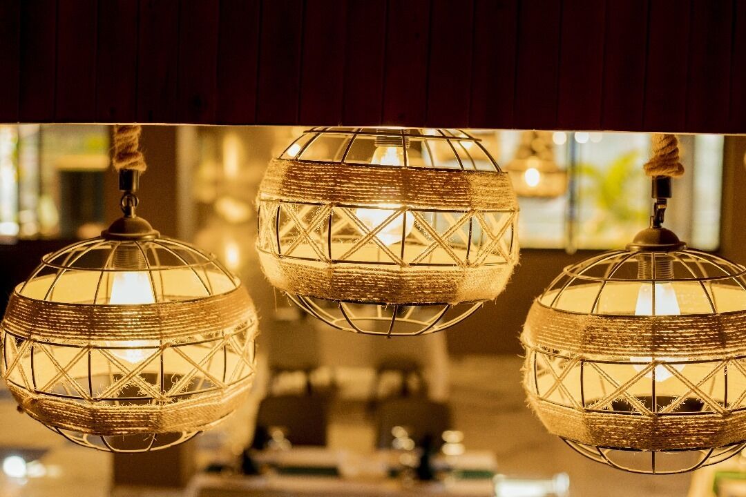 Three spherical hanging lights with a woven pattern.