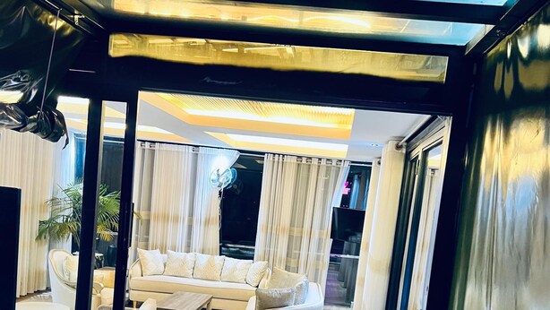 A modern living room with a sofa, armchairs, and a coffee table. - Eza Hotel (Kigali)