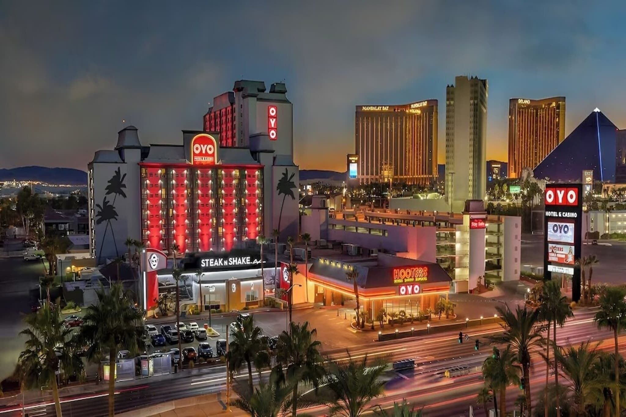 A hotel with a prominent OYO sign, a steakhouse, and a Hooters restaurant.