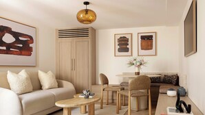 A modern living room with a sofa, coffee table, chairs, a small table, and artwork on the walls. - Modern Apartment a/c 1BR/2P - Saint-Germain (Paris)