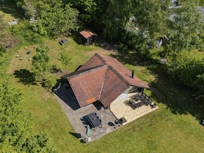 An aerial view of a house with a sloped roof, a patio with outdoor furniture, and a small shed in a wooded area. - "Petkana" - 4km from the sea by Interhome (Eskebjerg)