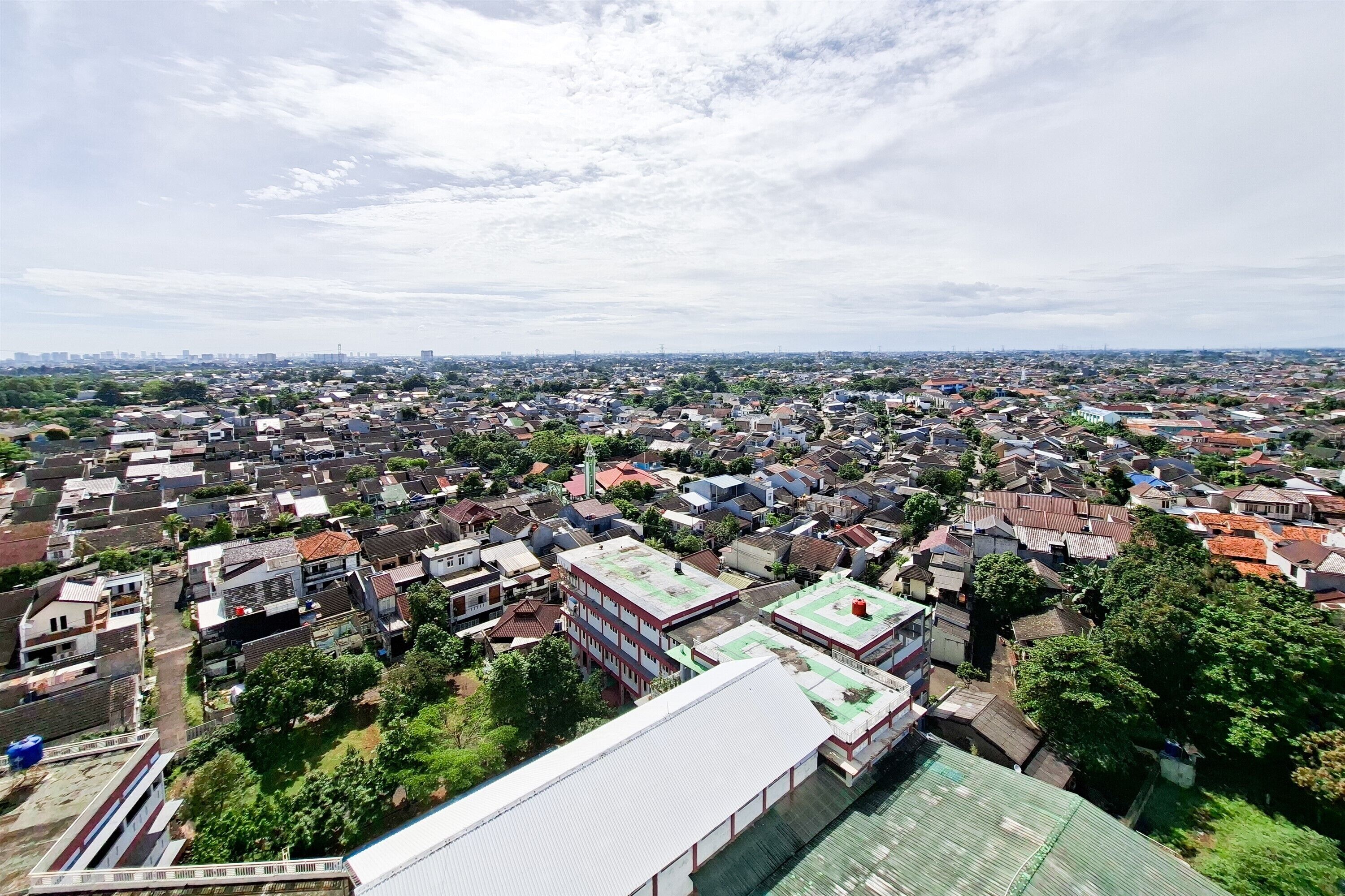 An aerial view of a densely populated urban area with numerous buildings and a mix of residential and commercial structures.