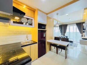 Standard Apartment | Private kitchen - Neat Warm Wooden Tone 1Br At Patraland Amarta Apartment (Ngaglik)