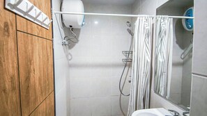 Standard Studio | Bathroom - Neat And Tranquil Studio At Delft Ciputra Makassar Apartment (Makassar)