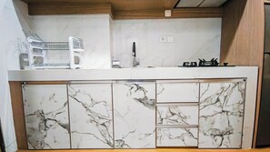 Standard Studio | Private kitchen - Neat And Tranquil Studio At Delft Ciputra Makassar Apartment (Makassar)