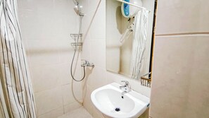 Standard Studio | Bathroom - Neat And Tranquil Studio At Delft Ciputra Makassar Apartment (Makassar)