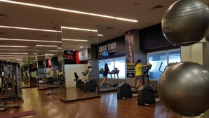 A gym with cardio machines, weightlifting equipment, and exercise balls. - Serene 2Br For 3 Pax At Tanglin Supermall Mansion Apartment (Surabaya)