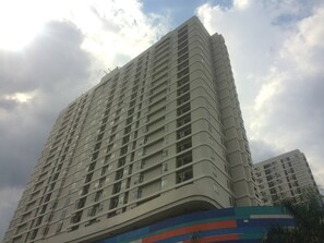 A high-rise building with multiple floors, featuring balconies and a modern architectural design. - 3 Pax Functional 2Br At Cinere Bellevue Suites Apartment (Depok)