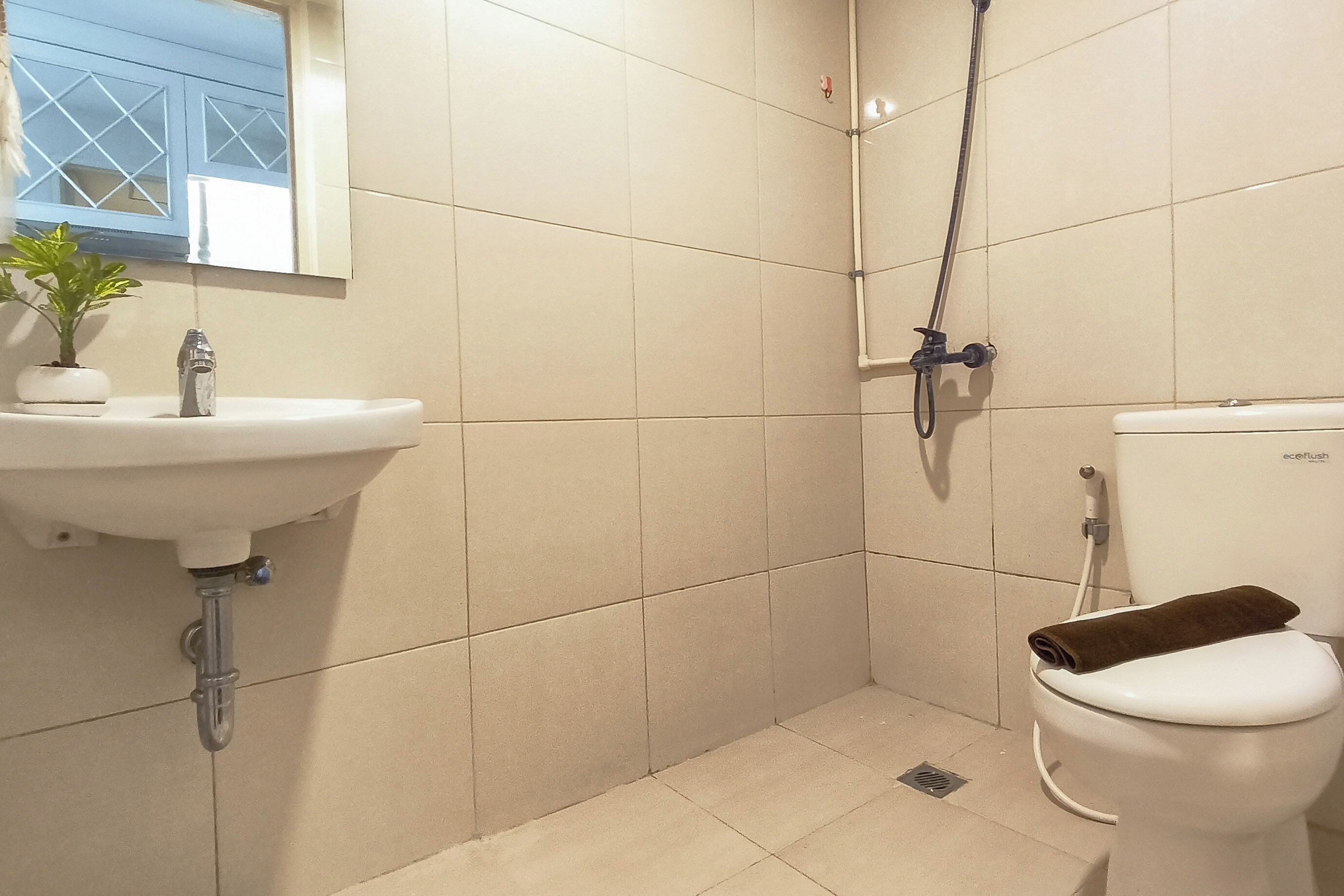 A bathroom with a sink, toilet, and shower.