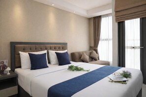 A hotel room with a large bed, a headboard, a nightstand, a chair, and a window with curtains. - Neat And Restful Studio For 2 Pax At Transpark Bintaro Apartment (Tangerang)