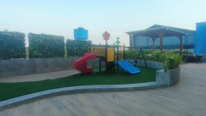 A playground with slides and a covered seating area. - 2 Pax Practical Studio At Suncity Residence (Sidoarjo)