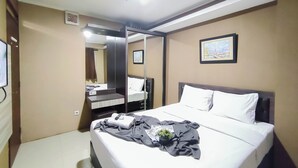 A hotel room with a bed, a bedside table, a mirror, a picture on the wall, and a ceiling light. - 4 Pax Warm Brown 2Br At Gateway Pasteur Apartment (Cimahi)