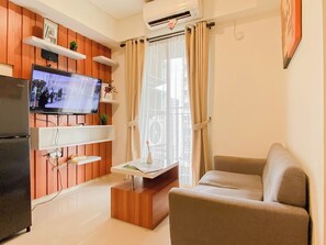 Standard Apartment | Living room - Homey Wooden Touch 2Br At Apartment Meikarta District 1 (Cikarang)