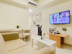 Standard Apartment | Television - Serene Beige 2Br Space At Apartment Meikarta District 1 (Cikarang)