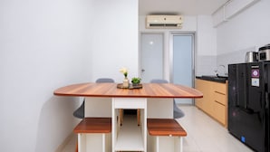 A modern kitchen with a central island, a built-in oven, and a refrigerator. - Strategic And Homey 2Br At Bassura City Apartment (Jakarta)