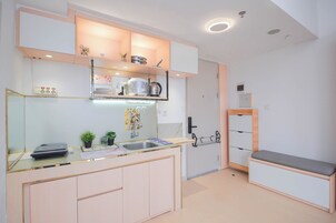 A modern kitchen with a countertop, sink, and cabinets.