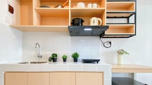 A kitchen with a sink, cabinets, a stove, and a refrigerator. - Practical Studio For 2 Pax At Tokyo Riverside Pik 2 Apartment Near Nice (Teluknaga)