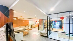A modern interior with a sofa, coffee table, and a glass partition. - Functional And Cozy Studio At Skyview Medan Apartment (Medan)