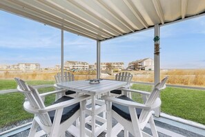 Outdoor dining - Bethany Bay First-Floor Condo with Pool, Tennis Court, & on site golf (Ocean View)