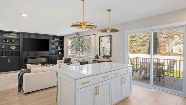 A modern kitchen with a large island, built-in appliances, and a dining area with a view. - Private Pool, Infared Sauna, Full Gym, Hot Tub, Sleeps 16 (Grandville)