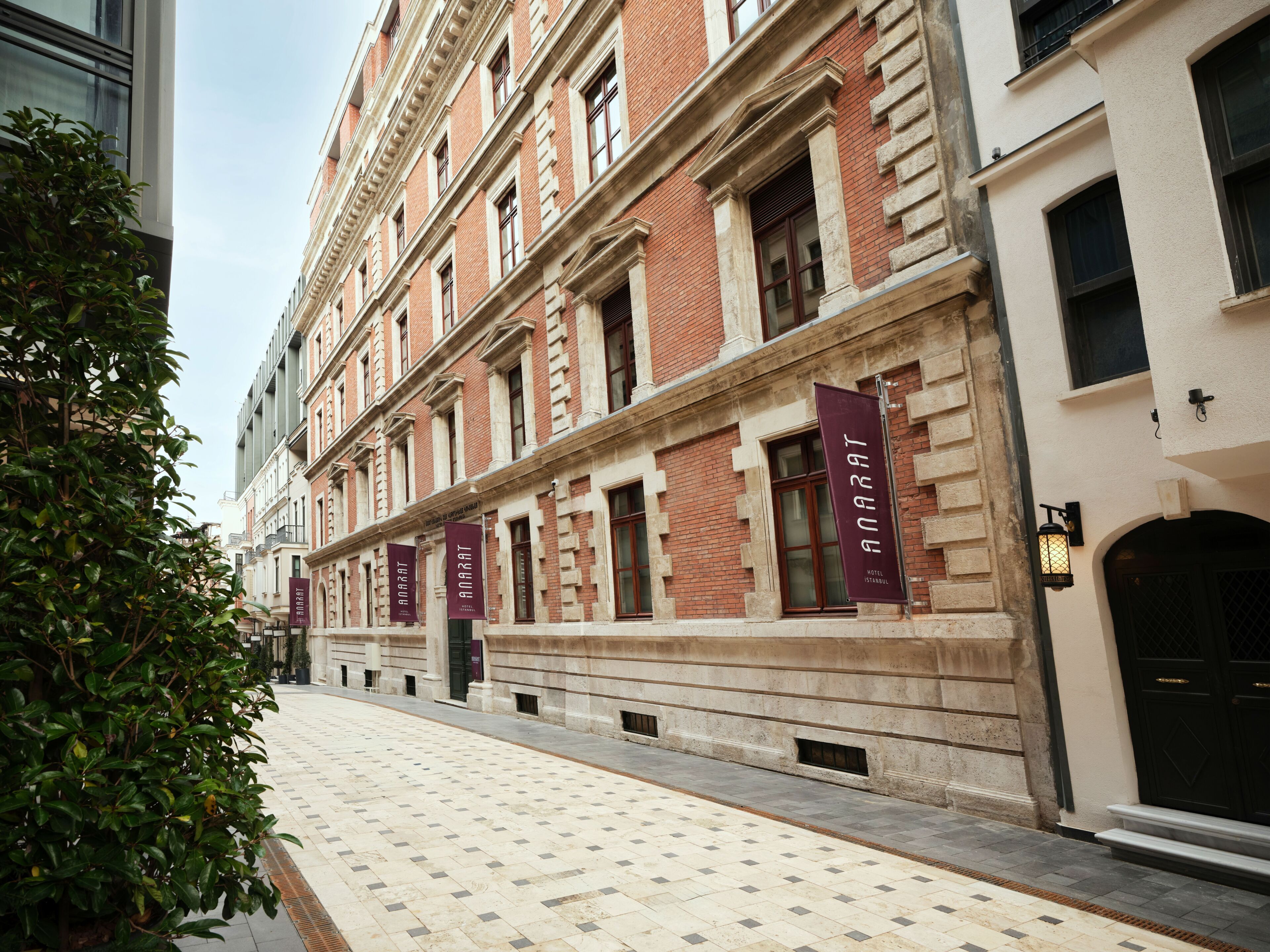 A building with multiple windows and a tiled walkway.