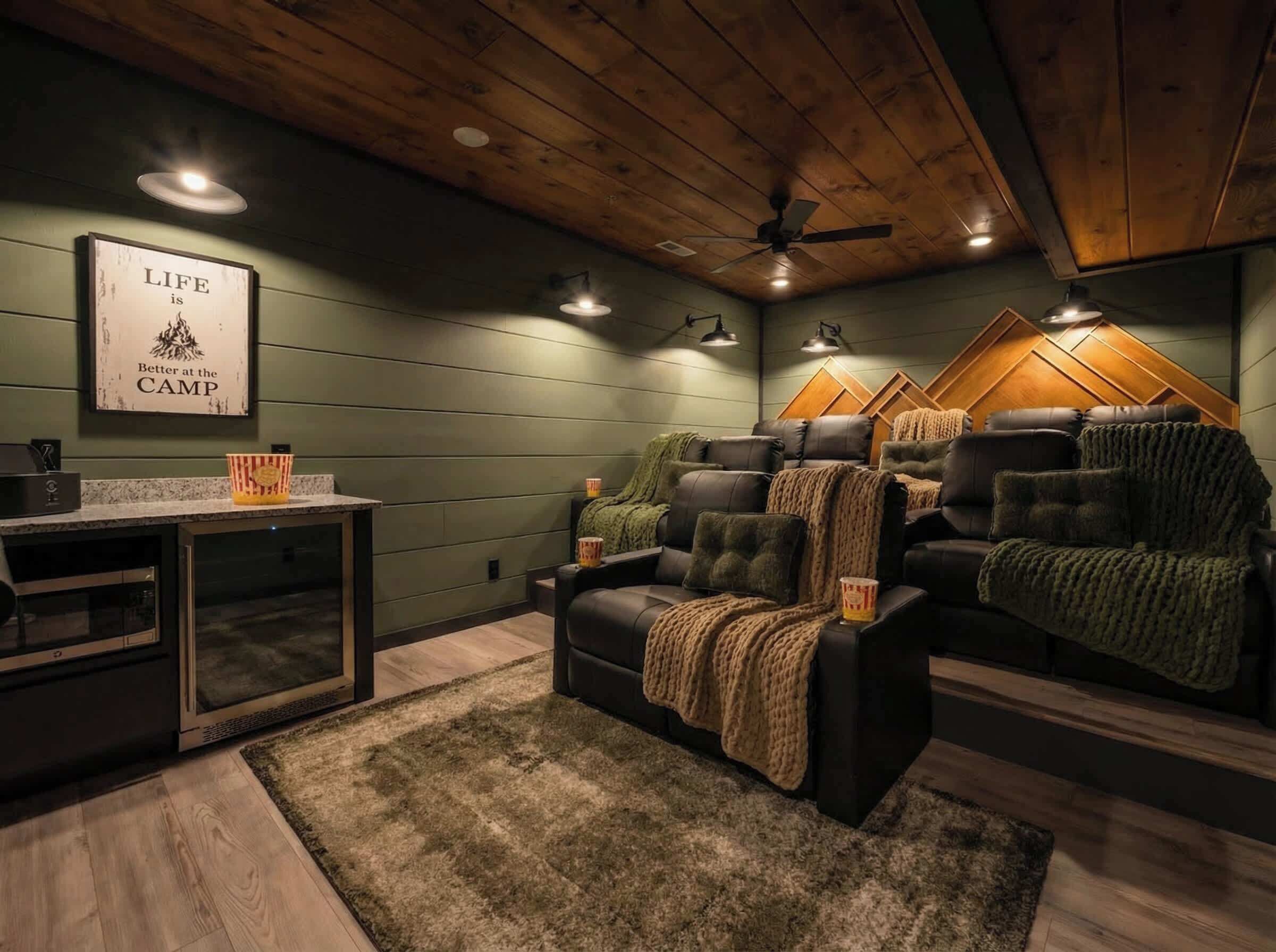 A cozy living room with a fireplace, leather sofas, a coffee table, and a framed quote on the wall.