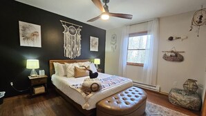 A bedroom with a bed, a ceiling fan, a nightstand, a window, and wall decorations. - Arrowhead Community Hot Tub Firepit Game Rm Movie Rm Fireplace Walk 2 Pool, Lake (Pocono Lake)