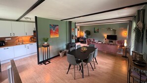 A modern interior with a dining area, kitchen, and living space.