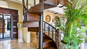 A spiral staircase with wooden railings and a potted plant beside it. - Spectacular Hillside Villa With Pool, Incredible Views (Puerto Vallarta)
