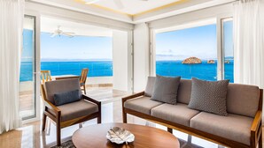 A modern hotel room with a balcony, a sofa, a chair, and a coffee table. - Oceanfront Condo With Huge Balcony, Sweeping Ocean View & Amazing Pool (Puerto Vallarta)