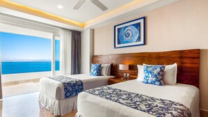 A hotel room with two beds, a ceiling fan, a large window with a view of the ocean, and a framed artwork on the wall. - Oceanfront Condo With Huge Balcony, Sweeping Ocean View & Amazing Pool (Puerto Vallarta)