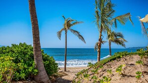 A beach with palm trees, sandy terrain, and the ocean. - Stylish Ocean-view Condo With Pool, Gym, Private Balcony, AC, & Wifi (Nuevo Nayarit)