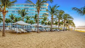 A beach resort with sun loungers, umbrellas, and palm trees. - Oceanfront Luxury With Amazing View, 4 Pools, Private Beach, On-site Spa, Dining (Nuevo Nayarit)