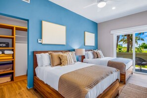 A hotel room with two beds, a wardrobe, and a view of the outdoors. - Ocean-view Getaway With Patio, Grill, Roof Deck, & On-site Pools (La Cruz de Huanacaxtle)