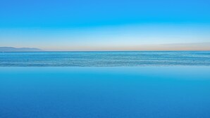 A clear view of a calm sea with a distant shoreline. - Oceanfront Studio With Infinity Pool, Breathtaking Views & Beach Access (Puerto Vallarta)