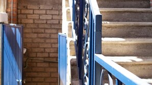 A staircase with a blue metal railing and a brick wall. - Authentic Mexican Hacienda: 1BR w/ Outdoor Kitchen, A/C & Fast Wi-fi in Bucerias (Bucerías)