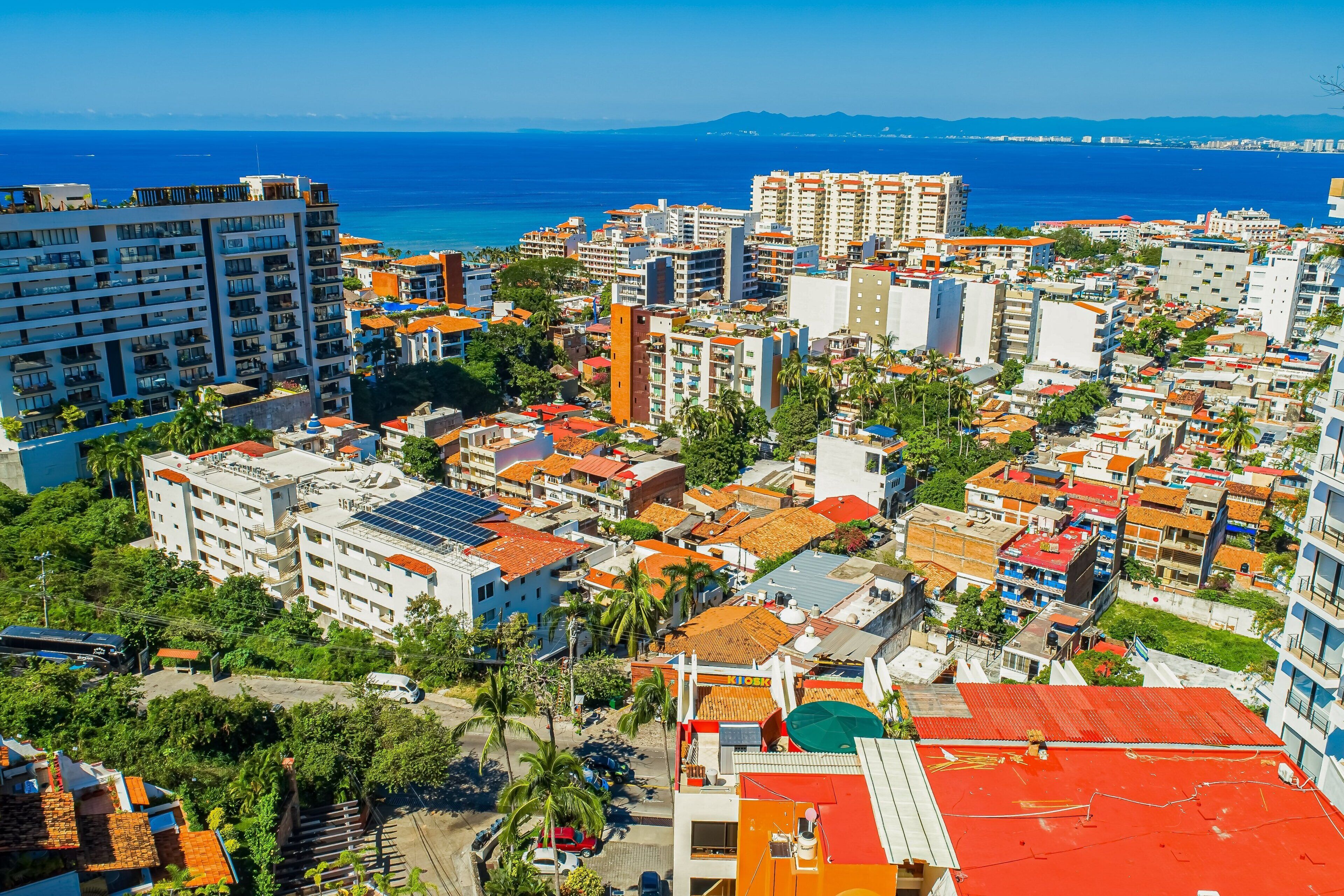 A coastal cityscape with a variety of buildings, including residential and commercial structures.