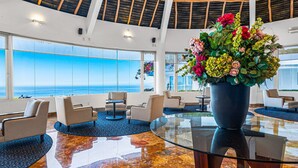 A spacious lobby with a large glass table, comfortable seating, and a view of the ocean. - Spacious Suite With Wraparound Terrace, Rooftop Infinity Pool & Resort Amenities (Puerto Vallarta)