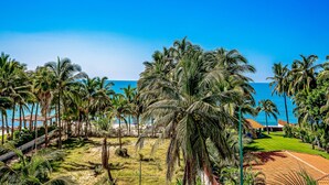 A tropical resort with palm trees, a pool, and a view of the ocean. - Ocean-view Penthouse With Private Plunge Pool & Terrace, Resort Pool (Nuevo Nayarit)