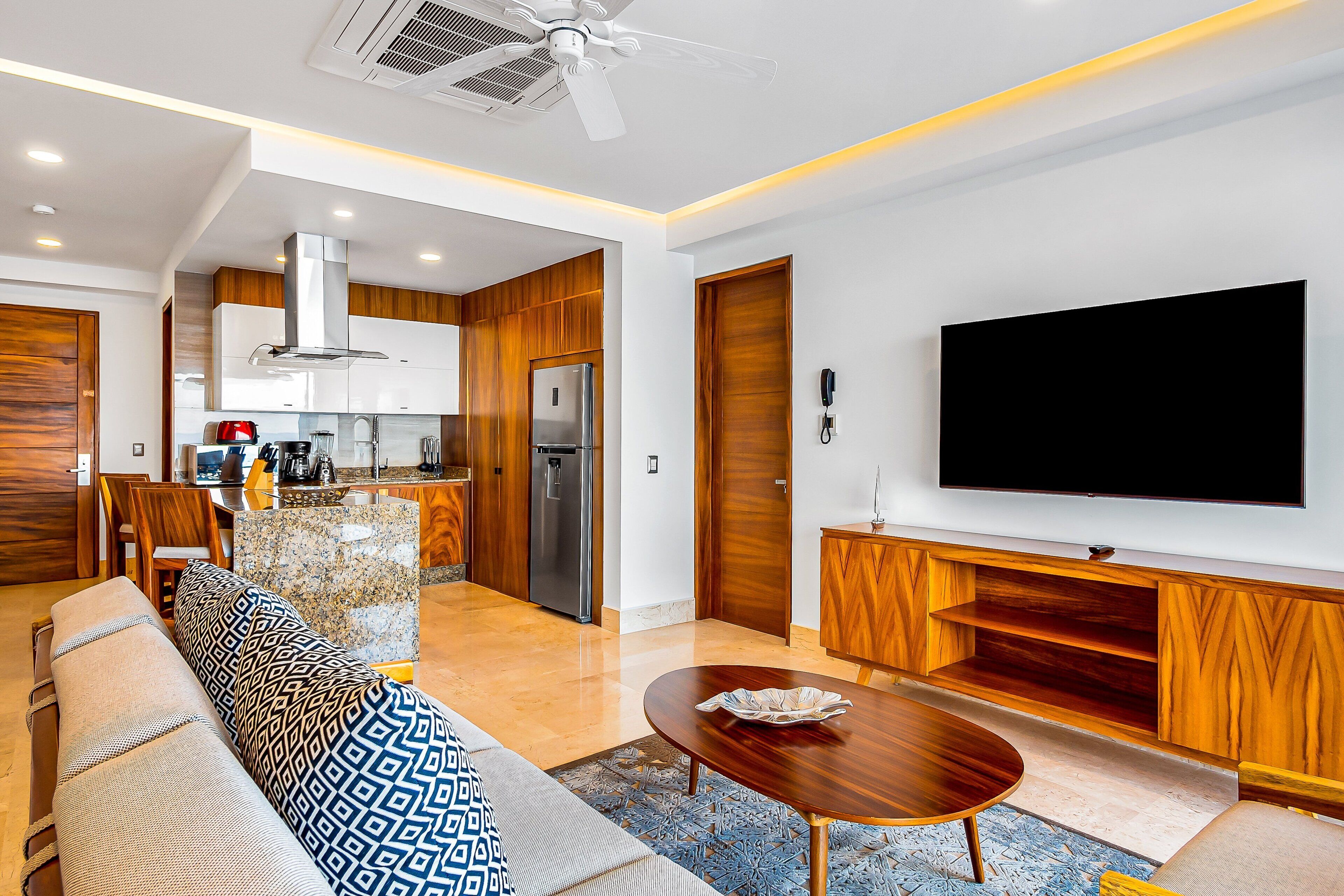 A modern living room with a sofa, coffee table, and TV.