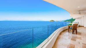 A balcony with a clear view of the sea and distant islands. - Luxurious Condo With Huge, Oceanfront Balcony, Pool & Pool spa (Puerto Vallarta)