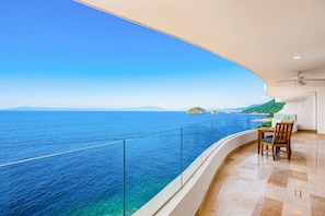 A balcony with a clear view of the sea and distant islands. - Luxurious Condo With Huge, Oceanfront Balcony, Pool & Pool spa (Puerto Vallarta)