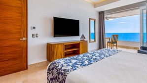 A hotel room with a large bed, a TV, a wooden desk, and a chair. - Inviting Waterfront Condo With Amazing Pool, Balcony & W/D (Puerto Vallarta)