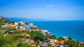 A coastal town with buildings, a clear blue sky, and the sea. - Gardenias Studio Studio in Puerto Vallarta With Panoramic Views (Puerto Vallarta)